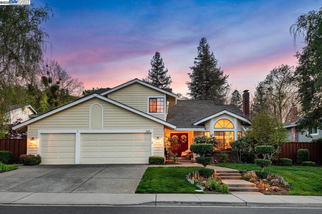 Discover this stunning 5-bedroom, 3-bath home in desirable Vintage Hills II, offering nearly 3,000 sq ft of living space on a spacious .26-acre lot. Enjoy a formal living room with vaulted ceilings, a stone fireplace, and a bay window showcasing a vibrant front yard. The formal dining room features corner windows overlooking the backyard. A wet bar leads to the kitchen and cozy family room with brick fireplace and sliding doors to a large covered patio. The kitchen includes ample counter space, electric range, oven, refrigerator, dishwasher, and wine fridge. A downstairs bedroom, full bath, and laundry room with 3-car garage access add convenience. Upstairs, the primary suite boasts tall ceilings, a soaking tub, shower, dual sinks, and walk-in closet. Three additional bedrooms share a full bath. Dual-zone HVAC and a whole-house fan provide year-round comfort. Enjoy hillside views, an iron-fenced yard, low HOA dues, and access to a private pool just steps away. Close to parks, top-rated Pleasanton schools, downtown, ACE Train, and tech buses.