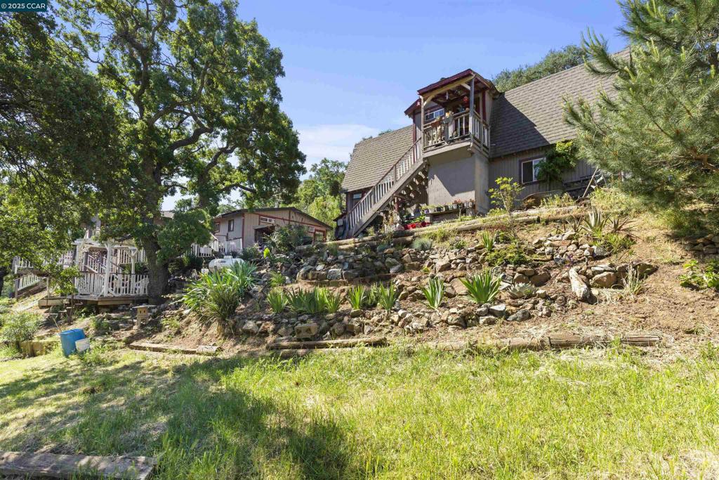 Stunning views from this single story 4 bedroom, 2 bath, plus 2 bed/1 bath, guest apartment or possible ADU and detached office. Located within the private gated Concord Mt. Diablo Trail Riders Association at the base of stunning Mt. Diablo. The club spans over 200 acres of nature with direct access to the beautiful Mt. Diablo State Park. While less than 10 minutes from town, when you're here you'll really feel like you are "in the mountains". One of the best-kept secrets in the East Bay. Adorable front porch and yards. Inside you will find a formal dining room, Eat in kitchen with loads of storage, spacious great room with wood burning stove, large laundry room, primary suite and en suite plus guest rooms of ample size. Ceiling fans and open concept for comfort. Owned solar, massive deck, chicken coop, horse shoe pit, on nearly one acre parcel. This is a horse lovers dream! Community pool, BBQ pit, clubhouse, and riding arenas, round pen, camping with stalls, Hunter Jumper Course. Amazing views! Large detached garage and workshop. So many possibilities. Ownership is a leasehold interest not a lease.