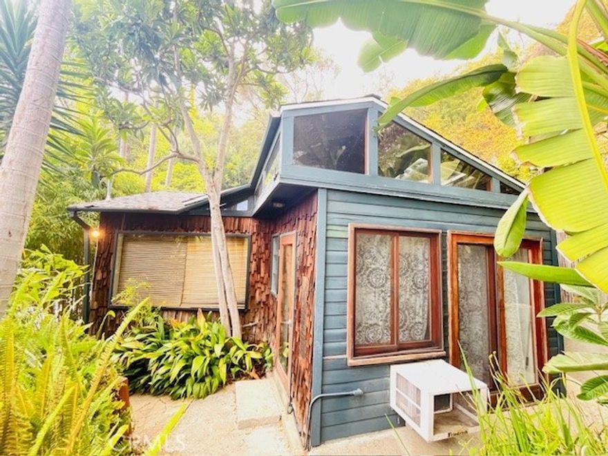 FAMILY TRUST AUCTION!!! SET IN TRANQUIL, PARK LIKE GROUNDS IS A RARE OPPORTUNITY TO PURCHASE A 1 BEDROOM, 1 BATHROOM PIED A TERRE HOME, WITH ADJOINING LOT, NESTLED IN THE ICONIC HOLLYWOOD HILLS, JUST BELOW THE LEGENDARY HOLLYWOOD SIGN.