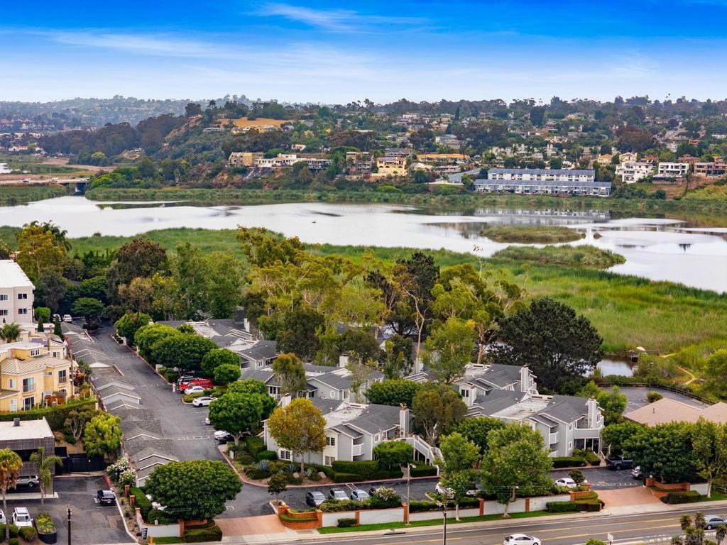 Coastal living at its finest! This light-filled condo with vaulted ceilings is just a few minutes walk to South O, Carlsbad Village & the beach. Featuring dual master suites with private balconies, updated LVP flooring, and a refreshed 2023 kitchen with white shaker cabinets, quartz counters, farmhouse sink & stainless steel appliances. Enjoy serene lagoon views from the kitchen, plus a detached garage & assigned space. Community pool & spa included. Walk to shops, dining & ocean breezes from this unbeatable location! The community is adjacent to the Buena Vista Lagoon and Nature Center, featuring hiking trails and fun for the whole family.