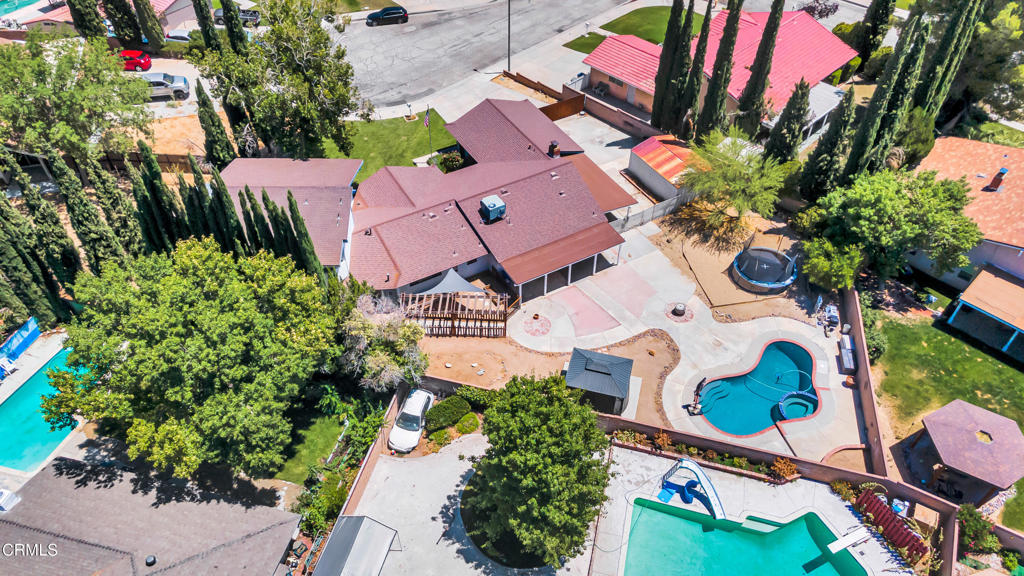 TWO HOMES IN ONE! This unbelievable property is a cant-miss opportunity! One of the most unique featured areas inside is a spacious permitted addition with its own living room, cozy fireplace, wet bar, and a private upstairs master suite with a walk-in closet and full bathroom. With the potential for 5 bedrooms and 4 full bathrooms, including two full baths in the addition (one on each floor with showers), this layout is perfect for multi-generational living or rental opportunities! The main home boasts an upgraded kitchen with refinished cabinets and new hardware, granite countertops, 9 feet of added cabinetry and counter space and brand-new stainless steel double ovens and stovetop with stylish upgraded tile flooring throughout. Enjoy peak outdoor living with a large backyard featuring a pool with new pool pump, two patio covers with new roofing and paint, a charming built-in gazebo and a spacious utility shed. There's also massive RV parking space, a new roof, an upgraded sewer line to the street and an added electrical panel in the backyard with plenty of power for an ADU addition. This home offers comfort, versatility, and room to grow -- don't miss this rare opportunity!
