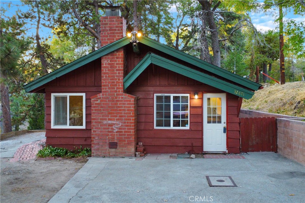 Nestled in the heart of Running Springs, this charming 2-bedroom, 1-bath mountain retreat blends rustic charm with modern updates. All on one level, enter the bright and open living area with open kitchen, ideal for relaxing or entertaining. Both bedrooms offer natural light and comfort, while the surrounding mature trees create a peaceful outdoor setting. This cozy cabin sits on a 6612 sq ft lot with a private driveway and enough room to park 4+ cars. Located in the serene Arrowbear neighborhood, this home is conveniently located near the main road and serves as a perfect getaway for nature lovers, first-time buyers, or short term rental investors. Whether you're escaping the city or looking for a full-time residence, this move-in-ready cabin captures the best of mountain living just minutes from hiking trails, ski resorts, and pristine mountain lakes. Do not miss this rare opportunity to own a slice of the San Bernardino Mountains!