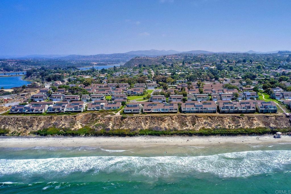 Coastal Luxury Awaits at Seabluffe – Discover one of Encinitas’ most sought-after oceanfront communities, where resort-style living meets timeless coastal charm. This fully renovated 3-bedroom, 2-bath, 1,485 sq. ft. single-family home with a private two-car garage blends modern design with relaxed beachside living. Step inside to soaring ceilings, abundant natural light, and an open floor plan designed for both comfort and style. The chef’s kitchen features stainless steel appliances, custom cabinetry, generous counter space, and a built-in desk area. A charming kitchen nook opens to the front patio, creating the perfect spot for morning coffee or casual dining. The inviting living and dining areas flow seamlessly outdoors to a balcony off both the living room and primary suite, ideal for soaking in ocean breezes. Every bedroom includes custom California Closets for maximum storage and functionality (owner spent $26K on CA closets). The spacious primary suite offers a spa-inspired bath, while the third bedroom includes a versatile loft space—perfect for a home office, reading nook, or flexible retreat. Added upgrades include a whole-home water softener system, plus the rare opportunity of unfinished space beneath the home with potential to build out. Seabluffe’s resort-style amenities make every day feel like a vacation: two pools, spa, tennis and pickleball courts, basketball court, playground, and lushly landscaped grounds within a secure, gated, guard-staffed community. Best of all, residents enjoy private beach access with steps leading directly to Grandview Surf Beach, one of Encinitas’ most iconic breaks. Just minutes from Leucadia’s shops, cafes, and restaurants, this home captures the best of coastal North County living. Whether you’re searching for a primary residence, a second home, or an investment property, this is a rare opportunity to own in Seabluffe, where homes seldom come available.