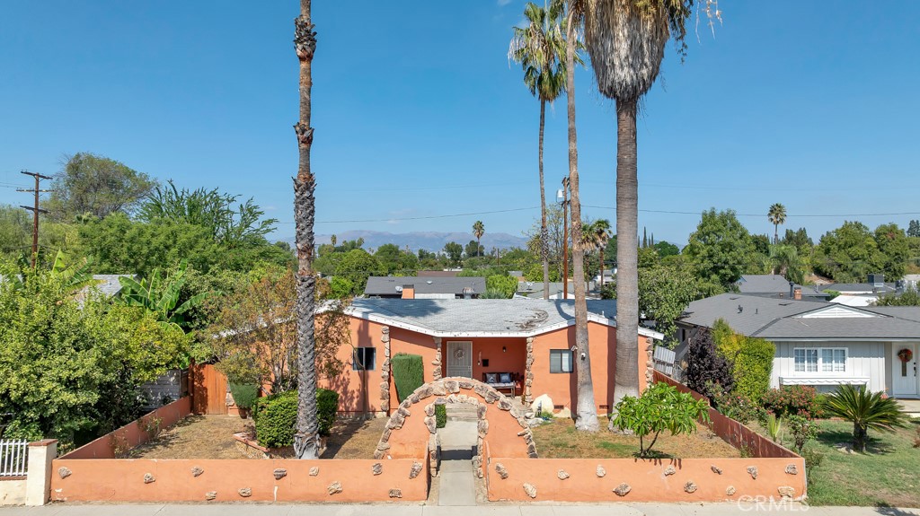 Welcome to a fantastic opportunity in the heart of Winnetka! This 3-bedroom, 2-bathroom home offers 1,420 sq. ft. of living space on a spacious 7,225 sq. ft. lot, perfect for buyers who want to create their dream home or investors seeking their next project. The home features a classic single-story layout with a bright living room, charming built-ins, and direct access to a covered patio and large backyard. The galley-style kitchen has generous cabinet space and opens to the dining area, providing a solid foundation for a modern redesign. The bathrooms showcase original details, giving buyers the chance to reimagine them with today’s finishes. Outside, you’ll find a large, private yard with mature palm trees and plenty of space to landscape, garden, or even add a pool. The detached garage and long driveway offer ample parking, and the garage which is connected to sewer and water is an excellent candidate for a conversion into an ADU, for extended family or rental for additional income. This property is ideal for contractors, flippers, or homeowners looking for a value-add opportunity. With some creativity and vision, this home can be transformed into a beautiful residence or an income-producing investment.