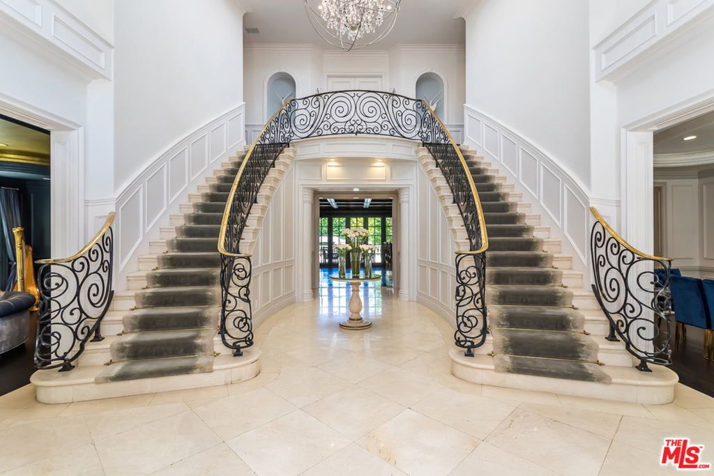 Derived from opulence in the heart of Beverly Hills. Underlined with intricate architecture, design, and the exhibition of first-class materials and artistry, the romance of this North Alpine estate is indisputable. Featuring a state-of-the-art temperature-controlled wine cellar, remote controlled smart-system A/C/lights/pool/spa, elevator and top-of-the-line security system, the gated two-story residence stands out amongst the Beverly Hills monuments. With 7 beds, heated floors throughout the full bathrooms and a home theatre, the perfectly placed villa is positioned just south of Sunset Blvd. Bask in city and tree top views from the expansive balcony off the master en suite with a walk-in closets. Counting the detached guest house, gym/yoga studio, sauna, heat repelling roof and outdoor kitchen/bbq with covered patios, the home has amenities galore. On private acreage with gated double entry into a pristine motor-court and four-car garage, 808 N Alpine Drive redefines luxury.