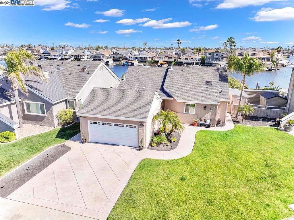 WATERFRONT LIVING AT IT'S BEST! STUNNING UPDATED SINGLE-STORY W/PRIME EASTERN EXPOSURE - LARGE ENTERTAINERS BACK DECK W/GLASS RAILING, OVERHANG FOR YEAR-ROUND USE - OVERSIZED DOUBLE DOCK PLUS SIDE TIE W/CANVAS COVER OVER HYDRO HOIST PLUS JET SKI RAMP - PAID SOLAR - DESIGNER TOUCHES THROUGHOUT - Open concept living area w/laminate/stone flooring throughout major living area - Updated chef's kitchen w/SS appliances and eat at bar - Great room w/high volume ceiling, updated designer electric fireplace w/custom mantel & wet bar w/mini refrigerator - Primary master w/water view, updated bath w/custom shower, dual bowl sinks & 3 closets - 2 additional secondary bedrooms & bath with updated fixtures and touches - Stamped concrete driveway & walkway - plumbed for hot tub - side yard w/2 sheds - Meticulously maintained - All this and more - This one will not last!!!