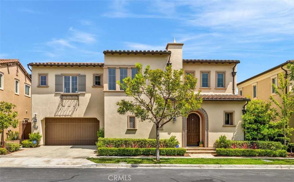 Welcome to this stunning residence nestled in the prestigious guard-gated community of The Groves at Orchard Hills. This beautifully upgraded 4-bedroom, 3.5-bathroom home blends timeless elegance with modern convenience, offering an open-concept layout ideal for both everyday living and entertaining. Step inside to find recently resurfaced hardwood floors that flow throughout the main-level great room and gourmet kitchen, while plush carpeting adds comfort to the bedrooms and upper level. The chef’s kitchen is a culinary dream, featuring granite countertops, a spacious island, and high-end KitchenAid appliances—including a built-in refrigerator. Large sliding California Room-style doors open to a private backyard retreat, complete with a built-in BBQ, and full outdoor entertainment system with integrated Sonos sound, perfect for entertaining. The first floor also includes a spacious guest suite with an en-suite bathroom, ideal for multigenerational living or hosting overnight guests. Upstairs, the luxurious primary suite features a generous walk-in closet, a spa-inspired bathroom with a soaking tub, dual vanities with designer tile backsplash, and a walk-in glass shower. Two additional bedrooms share a well-appointed full bathroom, and a versatile loft offers space for a home office, playroom, or media center. The upstairs laundry room includes built-in shelving, a utility sink, and 220V power for a large-capacity washer and dryer. The attached garage is equipped with a LiftMaster MyQ smart system and motorized storage racks for effortless organization. Additional upgrades include a Nest smart thermostat, Tankless water heater, Whole-home water softener, Tesla charging station, ADT security system, Exterior cameras with motion-activated floodlights. All of this is located within one of Irvine’s most desirable communities, offering access to award-winning schools, resort-style amenities, and scenic hiking and biking trails. This is truly a must-see property that defines elevated Irvine living.