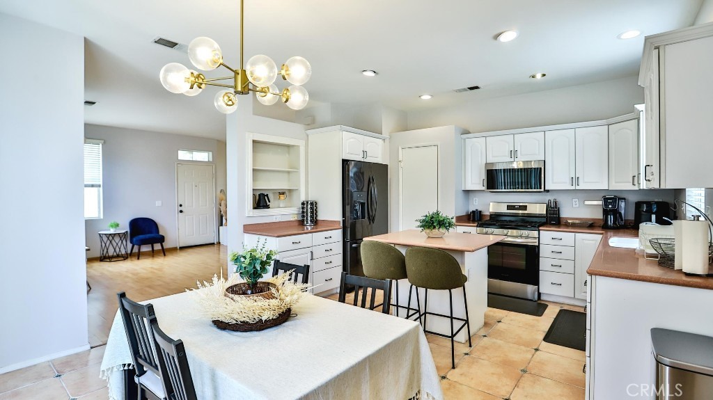 Welcome to this beautifully maintained single-family home located in the heart of Garden Grove, Orange County. Situated in a quiet, secure gated community, this rare end unit offers added privacy with no shared walls and more space than most neighboring homes. Built in 1997, the home features a bright and functional layout with expanded-size windows throughout, allowing for abundant natural light. Recessed lighting adds a modern touch, creating a warm and inviting atmosphere. The main level includes an attached two-car garage, a large kitchen with a dedicated dining area, a generous living room with a cozy fireplace, and a convenient half bath—perfect for everyday living and entertaining. Upstairs, the spacious master suite features a walk-in closet and dual-sink vanity. Two additional well-sized bedrooms, a full bathroom, and a versatile loft—ideal for a home office or second living area—complete the upper floor. Enjoy your own private backyard oasis with a covered pergola and a variety of fruit trees, perfect for relaxing or hosting gatherings. Additional updates include a recently replaced AC unit and water heater. Community amenities include a sparkling pool, landscaping and guest parking—all with a very low HOA. Located within the highly regarded Garden Grove Unified School District, this home is also conveniently close to Costco, major shopping and dining options, and just a short drive to Disneyland, the beach, and other popular Orange County destinations.
