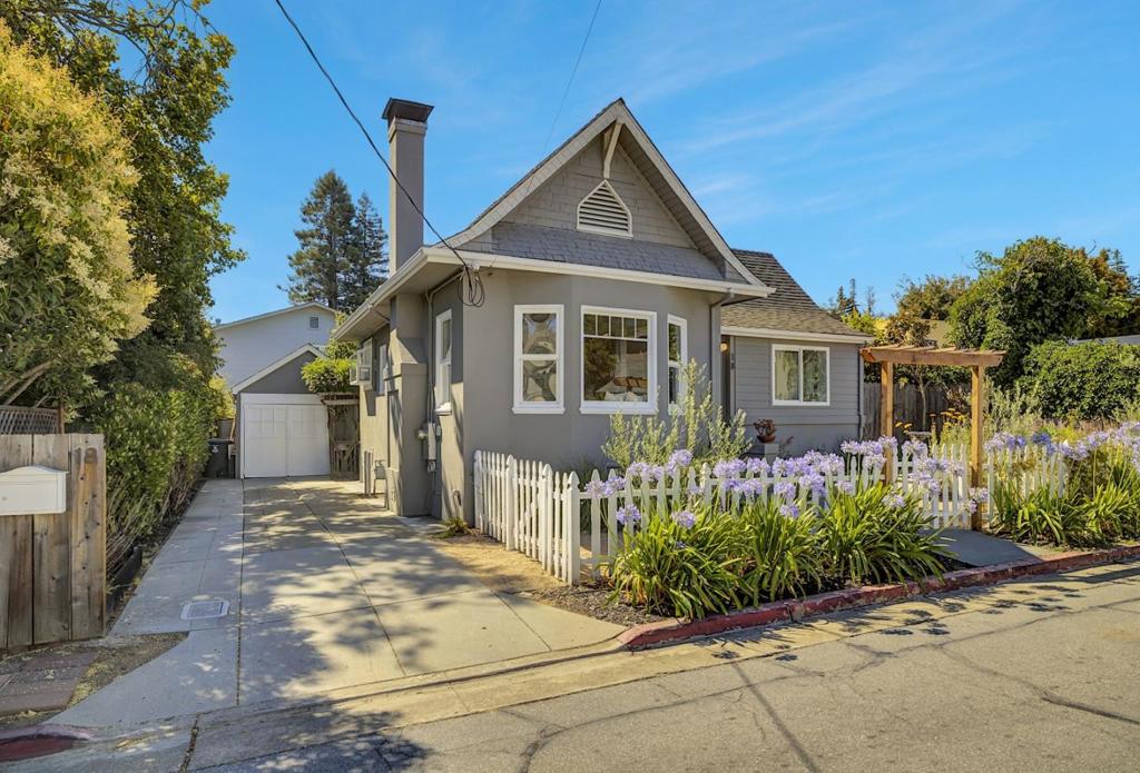 Nestled on a picturesque court, this enchanting storybook home offers a rare blend of timeless character and exceptional convenience. Perfectly positioned to enjoy the best of the Peninsula, you are just moments from the vibrant downtowns of both Burlingame and San Mateo. A formal entry and central hall welcome you into a home bathed in gorgeous natural light. The inviting living room, centered around a cozy wood-burning fireplace and elegant built-in bookcase, is the perfect setting for relaxing evenings. Host memorable dinners in the dramatic step-down dining room, distinguished by its magnificent cathedral ceiling that creates an atmosphere of airy sophistication. The spacious kitchen provides ample room for your culinary adventures and opens directly to the backyard, inspiring effortless indoor outdoor living and entertaining. Retreat to the large primary bedroom, a serene sanctuary featuring tall ceilings, generous closet space, and glass doors that lead to a private patio, your personal escape for morning coffee or quiet afternoons. Outside, the attractive mature landscaping provides a lush, private backdrop for the home. Combining architectural charm with an unbeatable location, this captivating home is a rare opportunity to own a piece of the Peninsula's best.
