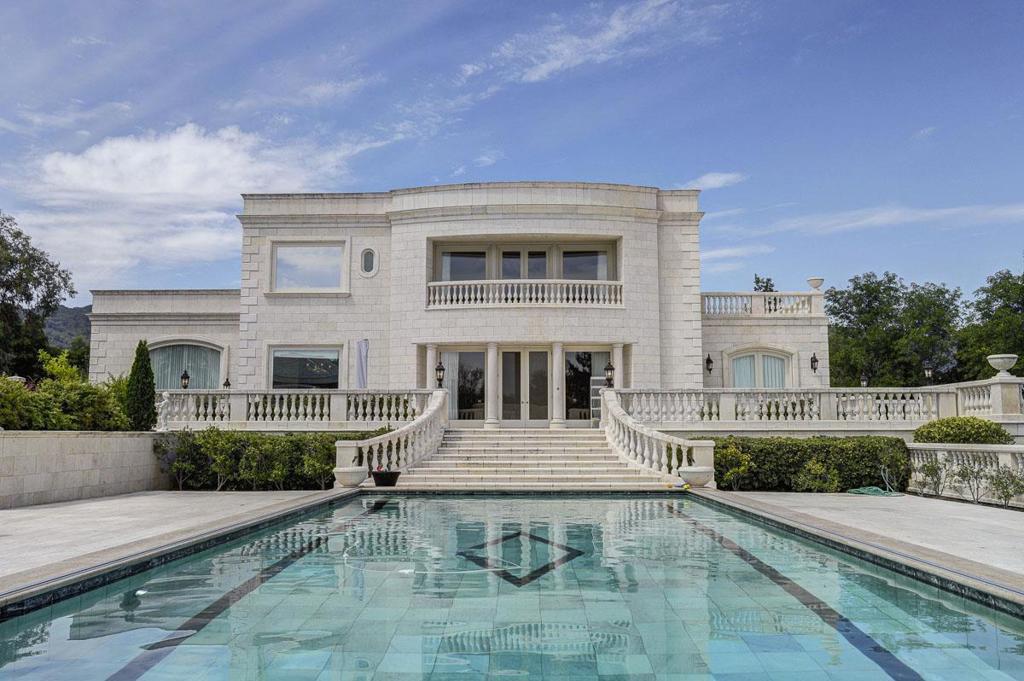 This luxurious Monte Sereno estate is located in one of the most prestigious estate neighborhoods in Silicon Valley. Excellent floor plan w/ phenomenal architectural design features:Main home has 3 fantastic bedroom suites, amazing private library/office, plus gorgeous full guest quarters with kitchen, bedroom & bath. Separate pool cabana with full bedroom, bath, & kitchen (square footage includes cabana and guest quarters). Five Car Garage. City lights, mountain views, privacy gate, beautiful pool, minutes to Los Gatos plus fabulous Los Gatos Schools.