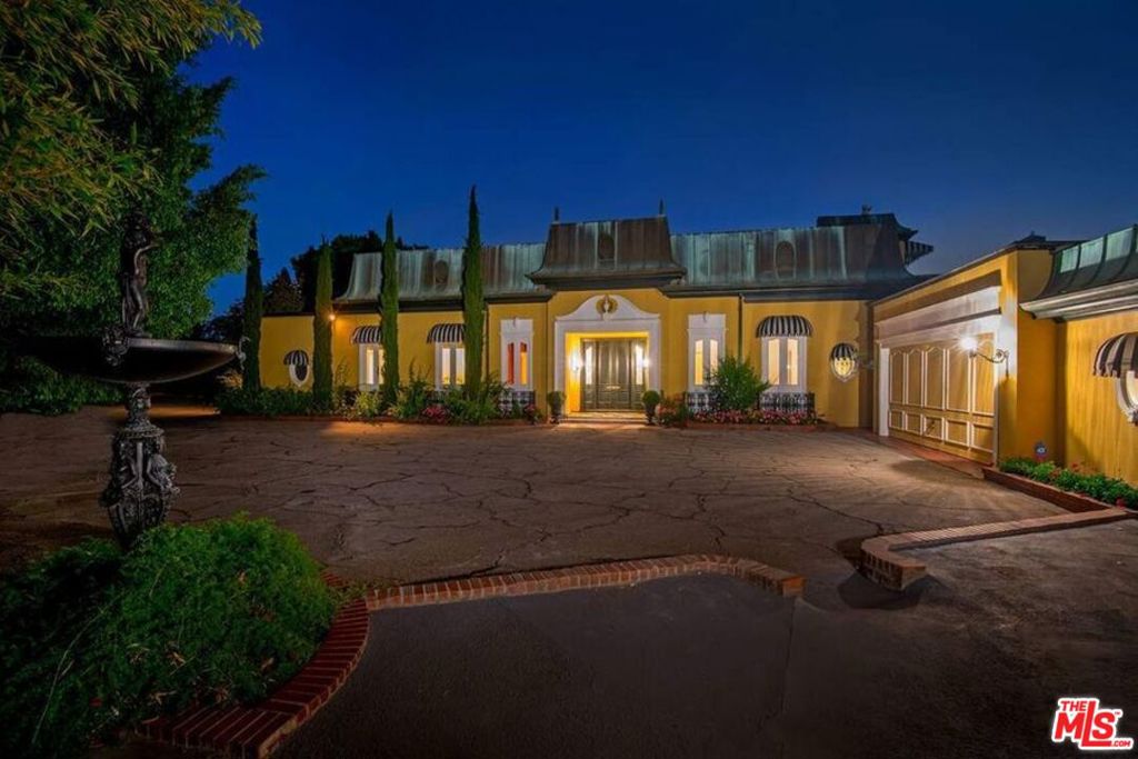 This classic architectural home, located in the coveted Bel Air East Gate area, once inhabited by the rich and famous, is situated on a private one acre promontory with expansive city and ocean views. A gated private driveway takes you up to a very large flat pad that contains the main residence, pool, two large parking areas as well as a 3 car garage. The residence main level contains a grand entrance, a formal living room, a formal family room, a grand master with a huge walk in closet, three guest suites, formal dining room, a large kitchen and a retro breakfast room. The second level contains a guest house with a large master bedroom, bath and closet, a bar, a grand living room, and a huge terrace with jetliner views from downtown to the ocean. The second floor is great for entertaining and parties. Either restore the property or tear it down and build a new iconic Bel Air trophy property.