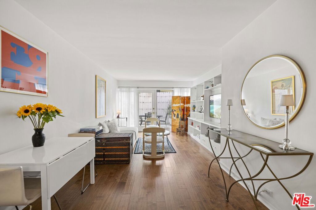 Own a piece of architectural history at the iconic Hollywood Riviera - one of Los Angeles' most celebrated mid-century buildings, designed by renowned architect Edward Fickett and recognized as a Los Angeles Historic-Cultural Monument. With Mills Act approval, this unique opportunity may offer significant annual property tax savings. Located on the main level with no stairs from street to door, this 1-bedroom, 1-bath residence offers effortless access and a seamless indoor-outdoor lifestyle. The oversized private patio is perfect for a quiet morning coffee or winding down under the stars. Inside, tasteful modern updates complement the original mid-century character, reflecting Fickett's signature clean lines and timeless design philosophy. As Fickett once noted, "Architecture is the art of sheltering man in all his moods." Unit #10 gently echoes the energy of both completion and fresh new beginnings - an ideal symbol for a home within a community that's stepping into its next chapter. Thoughtful property-wide improvements are currently underway, including upgrades to the pool, lobby, and walkways. This is a rare chance to be part of the building's evolution while enjoying the benefits of revitalized amenities upon completion.Surrounded by lush landscaping and located just minutes from the Sunset Strip, this peaceful retreat offers convenient access to West Hollywood's top dining, shopping, and entertainment.Additional features include gated parking, storage, on-site laundry, controlled access, and a community pool.