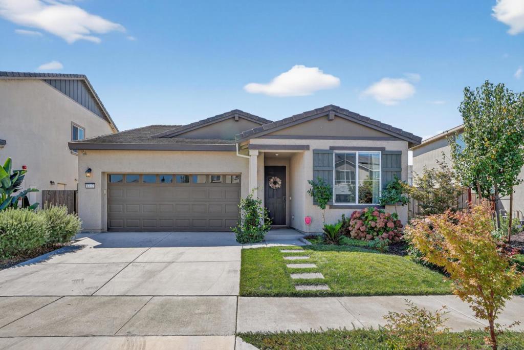 This 4 bed 2 bath single story home is located in the sought after Westlake community! The generous 5500 sq ft lot features a professionally landscaped backyard by System Pavers including 25 year transferable warranty. Home includes access to NEW West Lake clubhouse, pool & gym. Cozy up next to an electric fireplace media wall in the living room for movie night! The modern kitchen includes soft close cabinet doors & drawers, brass faucets, quartz counters and upgraded pendant lighting above a large kitchen island & durable stone tile floors. Dine under soft rattan lighting. Dimming LED remote control ceiling fans cool the living room and bedrooms. Cordless window shades installed in all bedrooms for privacy! A tankless water heater means you never run out of hot water! Out back, enjoy an artificial turf lawn & rounded wall sitting area, perfect for play & bonfires. The rear patio features low maintenance stamped concrete framed by graceful Italian Cypress trees & charcoal stained fencing. Landscaping is on automatic irrigation! Save on electricity w/ paid off solar on NEM 2.0 vs NEM 3.0 on new builds. 5 min. from shops, restaurants, schools, parks, walking/biking trail & hwy 5. Thoughtful upgrades make the home a must-see turn key. No projects to do, ready for an easy move in.