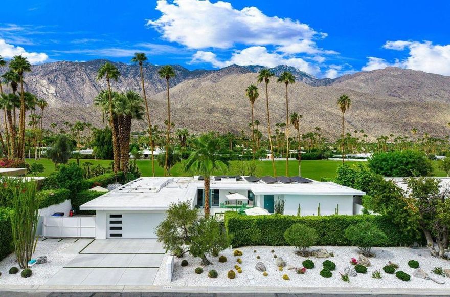 This exceptional midcentury residence is located on the 17th fairway of the Indian Canyons golf course in South Palm Springs, offering 360-degree mountain views. Meticulously remodeled by renowned Palm Springs designer Christopher Kennedy and previously showcased as the Modernism Week Showhouse, this home seamlessly integrates stunning La Cantina folding and pocketing glass doors to frame the spectacular fairway and mountain vistas. The property features multiple elegantly appointed outdoor living areas, including a convenient pass-through window from the kitchen for effortless entertaining. Upgrades include new front gates, a dedicated catering kitchen adjacent to the main social kitchen equipped with Wolf and Sub-Zero appliances, 2 dishwashers, and premium plumbing fixtures from Dornbracht, Brizio, and Duravit. Additional highlights consist of designer wall treatments, custom window coverings, bespoke cabinetry in the fully finished garage, a 35-panel owned solar system, automated blinds, and oversized porcelain slabs throughout the exterior spaces. Situated in one of Palm Springs' most desirable neighborhoods, this home exemplifies sophisticated, high-end design.