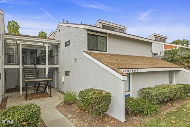 Ideal for first-time buyers! This move-in ready upstairs -end unit features a bright, open floor plan with vaulted ceilings and lots of natural light throughout. The updated kitchen and bathroom boast modern finishes, complemented by warm laminated wood flooring. Step outside to your private balcony, perfect for relaxing. Enjoy the convenience of an in-unit washer and dryer hook ups, plus two detached car garages for ample parking and storage. Located in a quiet, friendly neighborhood, this home offers comfort and style ready for you to move in!