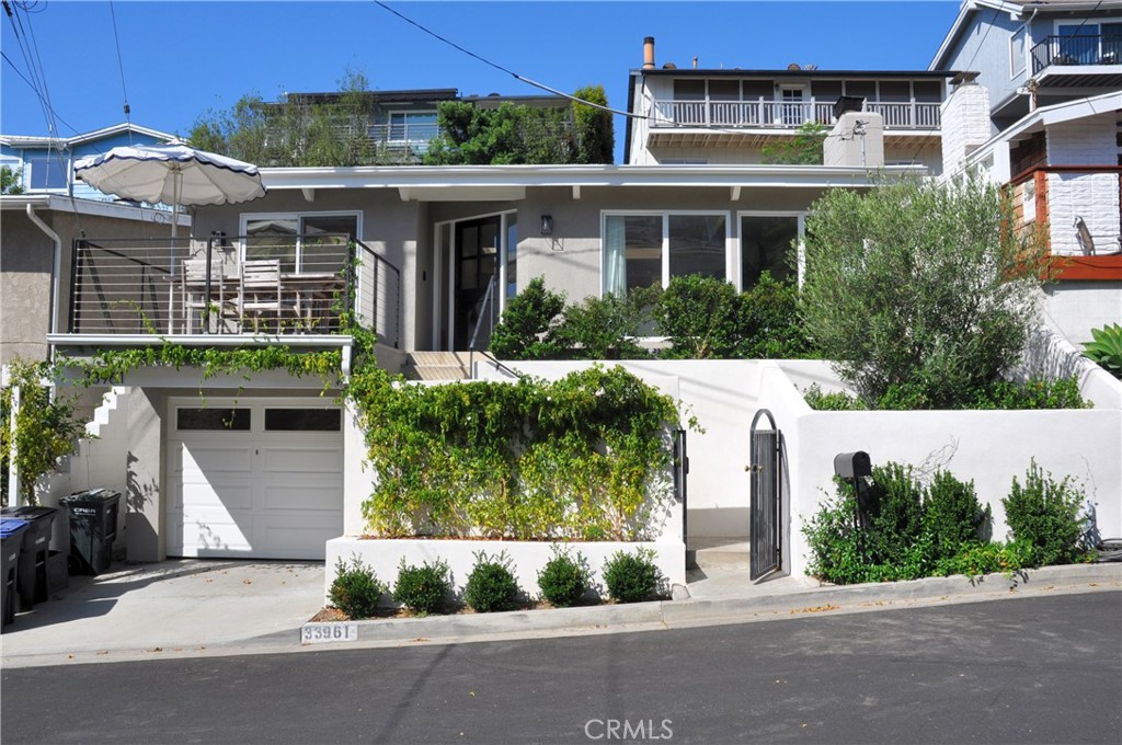 Welcome to this newly renovated beach bungalow. Situated on a quiet cul-de-sac, this gorgeous single-level home offers form, function, and a dream location, very close distance to Dana Point’s beautiful beaches and Dana Point Harbor. An incredible open floor plan flooded with natural light from skylights and floor-to-ceiling windows. Beamed ceilings and white oak LVP flooring throughout give the home a warm and comforting vibe. The kitchen features stainless appliances, Quartz countertops and backsplash, custom oak and white shaker cabinetry, and a convenient laundry room with outdoor access. The living room has a cozy fireplace and flows seamlessly to a spacious dining area that opens to the front deck. The primary suite features a walk-in closet and stunning en-suite bathroom with hand-cut tile, statement vanity, and walk-in shower with rain-head. The primary bedroom has direct access to the very private backyard with lush landscaping, and a cute space to string bistro lights and enjoy warm California evenings. The secondary bedroom also has its own en-suite bathroom. The spacious garage has enough space for an additional freezer or refrigerator. Also there is an EV charger and a Reverse Osmosis water filtration system! The home is walking distance to The Row, Doheny State Beach, Dana Point Harbor, and everything that embodies the quintessential beach lifestyle of Dana Point. This property is a truly rare find and a must see.