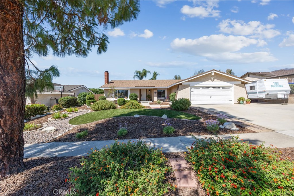 Beautifully maintained by the same family for over 34 years, this 3 bedroom, 2 bath, 1,533 sf family home is located on a quiet cul-de-sac street in beautiful Rancho Cucamonga. Property features include a remodeled kitchen with white shaker cabinets, quartz countertops and backsplash, modern sink and hardware, 2 tier Lazy Susan and stainless appliances. Luxury vinyl flooring flows through the living room, kitchen, dining room, hallway, and main bathroom. The entry and master bathroom feature new tile flooring, and both bathrooms have resurfaced sinks, countertops, showers, and bathtubs. Other notable updates include central heating and air conditioning system, ceiling fans in every bedroom, living room, and dining room, a wood burning fireplace in the living room, new interior doorknobs, light switches and electrical plugs. Enjoy year around entertaining in your private backyard with mountain views, large concrete patio area perfect for a BBQ, tables and chairs, spacious grass area ideal for children or pets to play, and side grass yard. Parking is provided in your attached 2 car garage with direct access and roll up door, or out front on your private concrete driveway that includes extra space for RV, boat or toy parking on the North side. Block perimeter walls surround the backyard, and there is also an iron double gate at the North side for additional backyard access. Located North of the 210 freeway near schools, restaurants & shopping at the Colonies Crossroads, Heritage Community Park, and easy access to the commuter friendly 210 freeway.