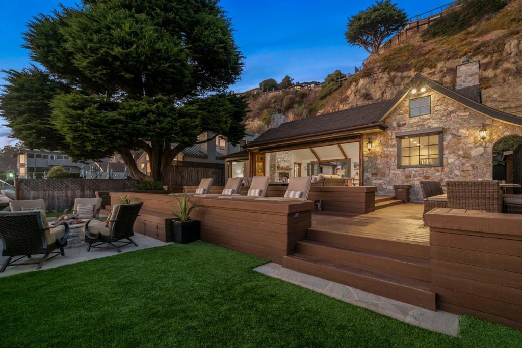 Beachfront Elegance. If you could somehow pick up an elegantly fully renovated & remodeled Carmel-style home including its exposed decorative beams, gabled roof & stately entry tower, artisan stone walls & cozy fireplaces; center all that around an inner flagstone courtyard w/its own roaring fireplace; & set it down on a beach surrounded by multiple layered decks sloping gently towards the sea, you'd have this one-of-a-kind masterpiece. Listen to the waves & watch the myriad sea animals & birds while enjoying the ocean breezes in your private gated retreat. The most stunning feature is a living room that opens fully to an expansive view of the sea, sand, & sun. The open floor plan has a chef-grade kitchen, en exquisite, spacious master suite & sitting area. The craftsmanship & materials devoted to every inch of this 2017 remodeled beach home combines the finest materials in a spectacular, breathtaking, yet amazingly private & exclusive location.