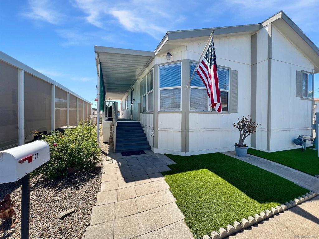 Welcome to Rancho Mesa, a gated 55+ senior community offering resort-style amenities and vibrant living! This well-maintained 3 bed, 2 bath home boasts 1,246 sq ft with vaulted ceilings, wood flooring, and abundant natural light. The kitchen features tile floors, stainless steel appliances, and gas cooking. Enjoy year-round comfort with central A/C, forced air heat, and a new A/C condenser. Outside, features include a covered porch, covered carport, and included golf cart. Community highlights include a pool, clubhouse, fire pit, BBQ area, shuffleboard, gym, library, and social events. Conveniently located near the 67, 52, and I-8 freeways with shopping and dining nearby. Land lease is $1,635/month. One of the most affordable 3-bedroom homes in all of San Diego County — move-in ready and waiting for you!