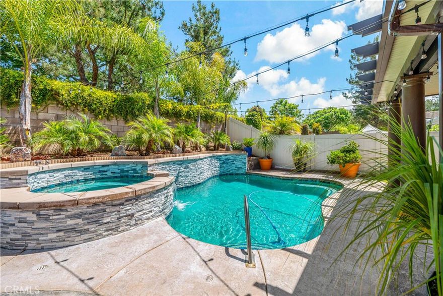 Stunning Upgraded Home with Private Pool & Spa in Wolf Creek - Welcome to this beautifully upgraded 2-story residence located in the highly sought-after Wolf Creek community of Temecula. This exceptional home seamlessly blends luxury, comfort, and functionality, offering an array of impressive features and access to outstanding community amenities. Step through the charming stamped concrete entryway into a thoughtfully designed floor plan. The home offers a versatile front room that’s perfect as a game room or additional living area, a formal dining room for entertaining, and an open-concept family room with a cozy fireplace that connects seamlessly to the gourmet kitchen—complete with granite countertops, stainless steel appliances, and a spacious breakfast nook. A highly desirable main floor bedroom and full bathroom provide convenience and flexibility for guests or multigenerational living. Upstairs, you'll find a generous bonus room ideal for a media or play space, a convenient laundry room with a utility sink, and a luxurious primary suite that features a comfortable sitting area, walk-in closet, and a spa-inspired bathroom. Additional features include a 3-car tandem garage and a paid-off solar system. Step outside to your private backyard oasis designed for year-round enjoyment. Relax in the sparkling pool and spa, dine under the covered patio, or gather around the built-in fire pit on cool evenings. The stamped concrete patio and low-maintenance landscaping complete this inviting outdoor retreat. Living in Wolf Creek means enjoying resort-style amenities that elevate your lifestyle. The community features a large recreation center with a sparkling pool, spa, and well-equipped fitness center, as well as a clubhouse for gatherings and events. Outdoor enthusiasts will appreciate the nearby Patricia H. Birdsall Sports Park—a 44-acre facility with lighted soccer fields, basketball courts, ball fields, playgrounds, and picnic areas. Residents also enjoy access to parks and scenic walking trails, including Pala Community Park and Kent Hintergardt Memorial Park. The community hosts year-round family-friendly events, creating a warm, connected neighborhood atmosphere. Located within the award-winning Temecula Valley Unified School District, this home is within walking distance to top-rated schools, including the highly acclaimed Great Oak High School. Don’t miss your chance to own this exceptional home in one of Temecula’s most desirable neighborhoods.