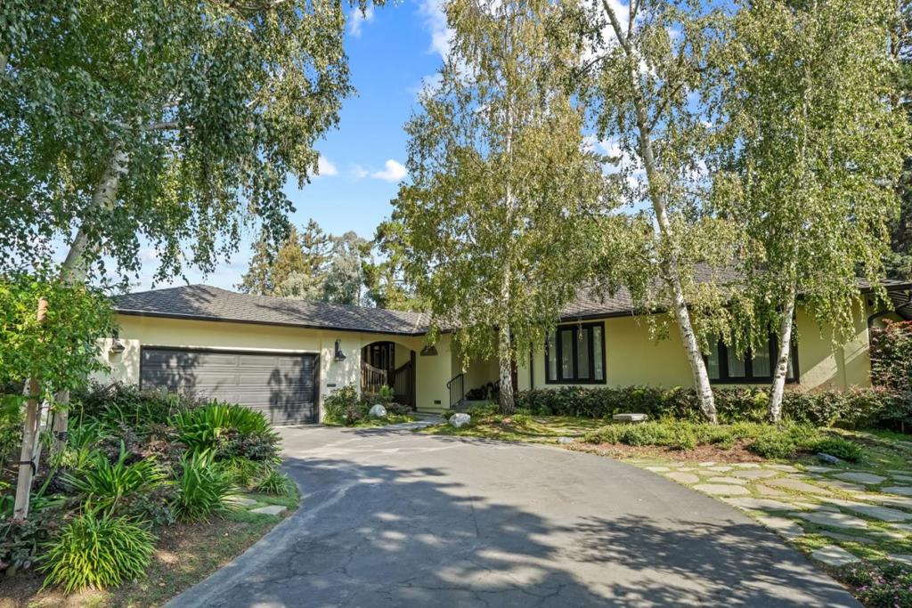 Reminiscent of a timeless European villa, this single-level residence blends classic elegance with eclectic flair, showcasing meticulous detail and high-quality finishes. Thoughtfully renovated, the home offers coffered ceilings, hand-textured walls, custom millwork, and rich oak hardwood floors. Pops of color, silk drapes, and French casement open-in windows enhance the inviting living spaces, while curated details like an antique oak linen closet and vintage cherry bookcase reflect a unique design aesthetic. A cozy den and sitting room offer a private retreat, while the spacious living room with fireplace opens to meandering gardens and lush landscaping for effortless indoor-outdoor living. The elegant dining room connects to the chefs kitchen with quartzite waterfall island, Wolf induction cooktop, Bosch appliances, and floor-to-ceiling cabinetry. Velux skylights bathe the space in natural light. The serene primary suite offers dual closets and a spa-like bath with soaking tub, porcelain slab shower, dual sinks, and heated floors. Two additional bedrooms share a stylish bath plus an office nook adds versatility. Finished two-car garage. Ideally located in Sharon Heights near Stanford, Sand Hill Road, and award-winning Las Lomitas schools.
