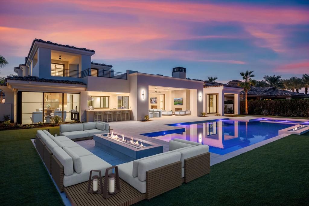 Step into a world of elegance & comfort with this magnificent 7,834 sqft new construction home. As you approach, the towering glass entrance sets the tone for the luxury that awaits inside. The spacious courtyard & a serene water feature will warmly greet you to set the mood for your stay. Upon entering, you're greeted by an expansive living room where pocketing doors invite the outdoor in, creating a seamless flow of space and light. The gourmet kitchen is perfect for your culinary adventures, complete with top-of-the-line appliances, a secondary kitchen & ample storage. The cozy breakfast room & stylish bar area make it ideal for both intimate family meals and grand entertaining. The primary bedroom - a sanctuary of calm & relaxation, features a large shower & a free-standing tub that invites you to unwind. Make your way to the upper level, where you'll find 2 inviting bedrooms, a cozy common area, & a spacious balcony with breathtaking, expansive views, perfect for enjoying sunsets & starry nights. Step outside to the ultimate entertainment area, boasting an outdoor kitchen & a large pool, overlooking the picturesque 2nd hole of the beautiful Pete Dye golf course. For added privacy, a separate 2-bedroom casita with its own living room & kitchen provides a perfect retreat for guests & family. Built with the finest materials, this home is a testament to quality & craftsmanship. Make this exquisite property your own & experience the pinnacle of luxury living at the Hideaway.