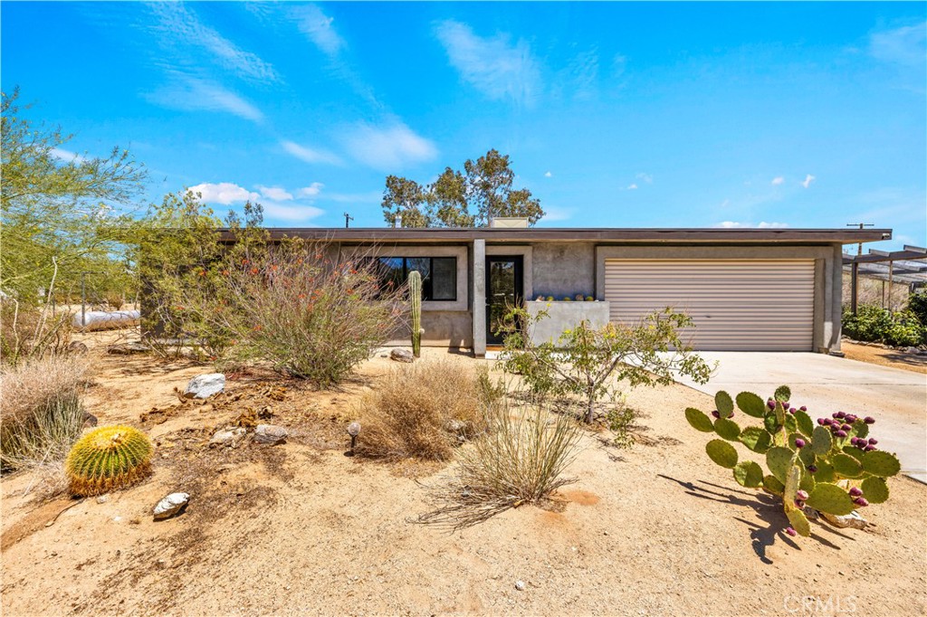 Turnkey Short-Term Rental Retreat | Fully Furnished | Prime Joshua Tree Location! Welcome to this beautifully curated 2-bedroom, 1-bathroom home, situated on a spacious and fully fenced 0.45-acre lot in the heart of Joshua Tree. Fully furnished and operating as a permitted short-term rental, this home offers an incredible opportunity for both personal enjoyment and investment. As you arrive, you'll be greeted by lush, diverse desert landscaping carefully designed for privacy and low maintenance. Inside, you’ll find beautiful polished concrete floors, neutral tones, and an airy, open layout filled with natural light. The updated kitchen boasts concrete countertops, stainless steel appliances, ample cabinetry, and open flow into the dining and living areas, ideal for entertaining. The 2 bedrooms are large and comfortable, and both offer great closet space. The primary bedroom even has direct access to the backyard. The spacious backyard is your own private oasis, complete with a covered patio, custom rockscape, spa, handmade pizza oven, outdoor bar seating, hammock structure and raised garden beds. Mature native plant life surrounds the property, enhancing the peaceful, immersive desert experience. All of this and just minutes from Joshua Tree National Park, downtown shops, and restaurants. Don’t miss this rare opportunity—homes with this much charm, care, and rental potential don’t last long. Schedule your private showing today!