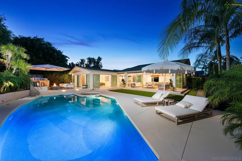 Single-level living - chic, modern design! Enjoy an open floor plan with a Nana folding glass wall that seamlessly extends to a spacious patio overlooking the pool and spa. Luxurious details—exposed wood, Viking appliances, custom white oak cabinetry, and Brazilian granite countertops—enhance the minimalist aesthetic. Three bedrooms, an office, and a den are set against a resort-style outdoor backdrop. The solar-heated pool, spa, and lushly landscaped grounds create a private oasis perfect for relaxation and entertaining. Located in the heart of the Village near the beach and local shops and dining. Designed for both comfort and style, every detail of this home has been carefully curated to maximize functionality while maintaining an air of sophistication. The Viking-equipped kitchen featuring a large center island, warm Brazilian granite countertops, and custom white oak cabinetry that provides ample storage. An under-counter microwave enhances convenience, while a discreetly tucked-away butler’s pantry offers additional space to keep the open living areas uncluttered. The primary suite, framed by two oversized French doors that gracefully open to the expansive rear of the property, allows for an effortless connection to the outdoors. The spa-like primary bathroom is designed for ultimate relaxation, featuring a spacious soaking tub, a glass-enclosed walk-in shower, and a generously sized walk-in closet. A dedicated office and additional den provide flexibility for additional living options. Outside, multiple areas for entertaining extend the living space, with an inviting outdoor dining area, a poolside lounge, and lush greenery creating a tranquil setting. The solar-heated pool and spa are enhanced by a serene water feature, adding to the resort-like atmosphere. There is a 2 car garage w/two additional parking spaces in the driveway, a gated front courtyard and located on a cul de sac, situated on a 10,900 SF lot.