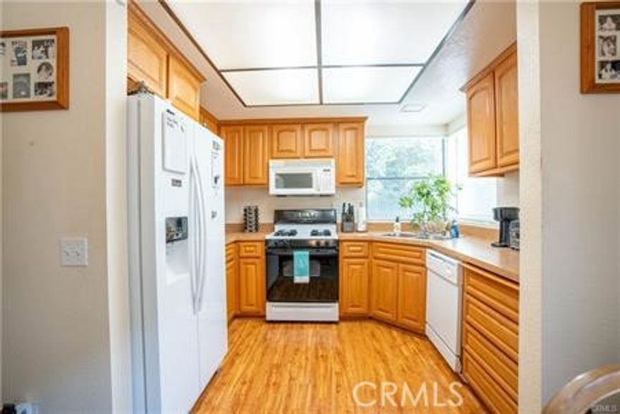 This spacious condo features an open floor plan, as you enter the unit you'll find the living and dining areas with a beautiful gas fireplace just next to a sliding door accessing the shady porch outside.You can walk to the kitchen directly from the living room and it features laminate wood flooring, a dishwasher, a great amount of cabinet space and large windows that let in the beautiful natural light. The bathroom features a double-sink vanity with quartz counter and dual entrance from the master bedroom and the hallway. Both bedrooms include carpet flooring and the master has a large mirrored closet with plenty of space! Don't forget your laundry is inside with a convenient stackable unit located in the hallway. This home also includes two assigned carports for parking and access to the amenities which include 3 pools and spas, 4 tennis courts and a clubhouse. As if this was not enough, this community is located near walking trails, the Diamond Bar Golf Course and the 57 and 60 freeways. Go to RentSpree link to apply.