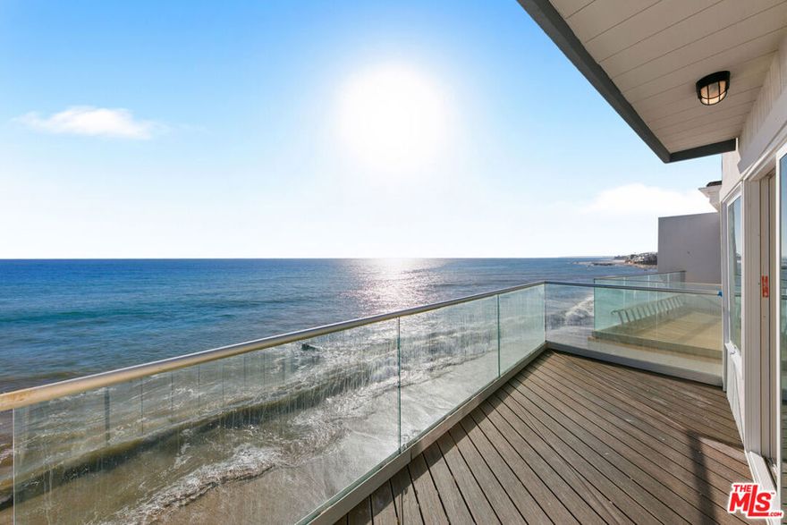 This residence sits directly on Big Rock Beach, perfectly positioned just minutes from Santa Monica and central Malibu. A rare offering on leased land at $2,100 per month (plus approx. 3% annual increase) with 38 years remaining on the lease. This beach home captures unobstructed, panoramic views of the Pacific Ocean, Catalina Island, and the Queen's Necklace from sunrise to sunset. The home features two bedrooms, plus an open den or 3rd bedroom area, and 2.5 bathrooms. The open-concept kitchen and dining area flow into a sunlit living room with a balcony perched over the sea, offering a front-row seat to the rhythm of the waves. Upstairs, the romantic primary suite includes an oceanfront balcony and spa-style en-suite bath, while the open loft/family area leads to a private guest suite with its own bathroom, and the laundry is in a closet upstairs. Multiple outdoor deck spaces create an effortless connection to the coast, from an ocean-facing deck ideal for lounging to a private subterranean patio made for al fresco dining beside the surf. A few doors away there is access to a picturesque pocket beach and cove, an idyllic escape for sunbathing, swimming, or quiet walks by the water at low tide. There is an attached 2 car garage. Own the whole building, the adjacent home is for sale as well!