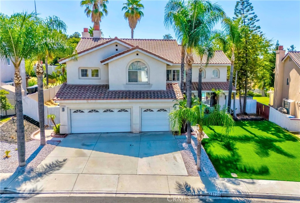 Welcome to the prestigious Sunnymead Ranch Community, beautifully tucked in the scenic hills above Moreno Valley! This lush, LAKE CENTERED neighborhood is renowned for its tranquil atmosphere and features one of the LARGEST LAKES in the county—perfect for boating, fishing, and enjoying resort-style amenities such as a clubhouse, fitness center and more.
Set on a MASSIVE lot, this 4-BEDROOM residence boasts striking curb appeal with newer drought-resistant turf and a HUGE BEAUTIFUL LUSH TROPICAL backyard oasis featuring a sparkling pool—perfect for entertaining guests or unwinding in your own private paradise. The backyard is truly VACATION LIKE, offering endless space for kids, pets, and gatherings!
Inside, a grand double-door entry opens to soaring vaulted ceilings and light-filled interiors. The layout is thoughtfully designed with 2 MASTER BEDROOMS, each with ensuite baths—one conveniently located downstairs, and a luxurious primary retreat upstairs complete with a dual-sided fireplace, spa-inspired bath with jetted tub, walk-in shower, dual vanities, oversized walk-in closet, and a private balcony with sweeping views.
Generous living spaces include a formal dining room, formal living room, family room with fireplace and custom wet bar, and a versatile open-concept chef’s kitchen with granite countertops, stainless steel appliances, upgraded cabinetry, and walk-in pantry. Upstairs, a SPACIOUS LOFT offers endless options as a den, game room, or even a bedroom, alongside two oversized bedrooms with a dual-sink hall bath. Included is a dedicated office which can also be used as a bedroom, adding even more flexibility.
Practical luxuries include abundant storage, an individual laundry room, and direct access to the three-car garage with plenty of additional parking. Modern upgrades enhance comfort and efficiency, including smart lighting, a water softener system, tankless water heater, NEW CENTRAL AC, and solar panels.
Located near easy commuting, shopping centers, and dining, this home blends everyday convenience with resort-style living. Come see it before it’s gone—this rare find truly has it all!
