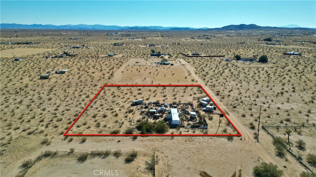 Opportunity knocks! This 2-bedroom, 1-bath mobile home sits on 2.5 acres of scenic land and includes a bonus room perfect for an office or potential third bedroom. A true fixer-upper with solid basics—electric and water meters already installed—offering huge potential for the right buyer. Enjoy breathtaking desert views and a convenient location just a short drive from King of the Hammers, the beloved La Copine restaurant, downtown Joshua Tree, and the entrance to Joshua Tree National Park. Whether you're looking to renovate, build new, or invest, this property has endless possibilities.