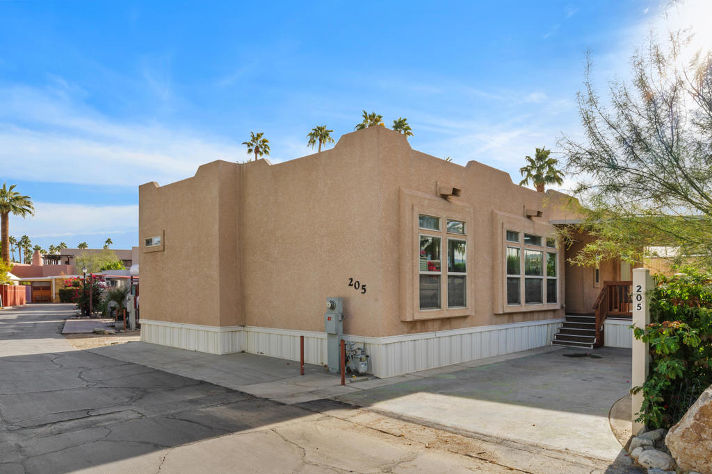 Welcome to this spacious and light-filled manufactured home in the highly sought-after 55+ Ramon Park community of Palm Springs. This rare and generously sized Cavco Spanish Pueblo-style stucco home, built in 2010, offers comfort, charm, and modern convenience. Inside, you'll find elegant engineered hardwood flooring, energy-efficient LED lighting, and an open-concept layout that seamlessly connects the kitchen, living area, and full-size laundry room. Each bedroom includes a walk-in closet for ample storage, and a dedicated gas line to the outdoor BBQ makes entertaining a breeze. Dual-pane windows throughout the home bring in abundant natural light, creating a warm and inviting atmosphere. The home has been well-maintained and thoughtfully updated, including a 2-stage furnace and 2-stage A/C unit installed in 2022. It also comes fully furnished--move-in ready! Enjoy year-round outdoor dining under the covered patio while taking in the scenic views of the San Jacinto Mountains. The lot rent for the new owner will be $921.98 per month and includes water and trash service, with a flat sewer fee of $20.50. Gas and electricity are metered and billed monthly. Prospective buyers must be approved by park management and meet the income requirement of 2.5 times the lot rent ($2,304.95/month). Rentals are permitted with park approval for a minimum of 30 days--short-term or Airbnb rentals are not allowed. Ramon Park is known for its mid-century charm and is featured annually on the local architecture tour. Residents enjoy access to a wide range of amenities, including a year-round heated pool, spa, clubhouse, library, banquet hall, shuffleboard courts, and a fitness center--ensuring an active and engaging lifestyle. Don't miss the opportunity to own a stylish and turnkey home in one of Palm Springs' most vibrant 55+ communities!