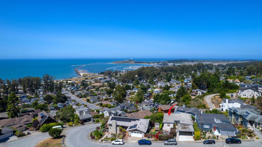 Perched above the Pacific Ocean and Pillar Point Harbor in the sunny banana belt of the San Mateo Coast, this 3 bedroom, 2 bathroom home offers breathtaking whitewater views which include Mavericks surf break, all visible right from the spacious deck. The oak hardwood floors have been refinished and the interior boasts fresh paint. The spacious open-concept living & dining area flow effortlessly onto the large view deck. The primary bedroom enjoys the same views & deck. The open beam ceilings throughout add structure and volume to this unique home. The mostly level fenced backyard offers space for gardens and includes an existing poultry coop while the spacious front detached deck provides a quiet respite. The sellers offer opproved Planning Department Plans for a 648 sq. ft. ADU with separate outside entrance which would also be suitable for a guest suite or creative retreat. Located just moments from Surfers Beach, restaurants, local entertainment and shops, this home offers the best of coastal living - just 30 minutes from SFO, San Francisco and Silicon Valley.