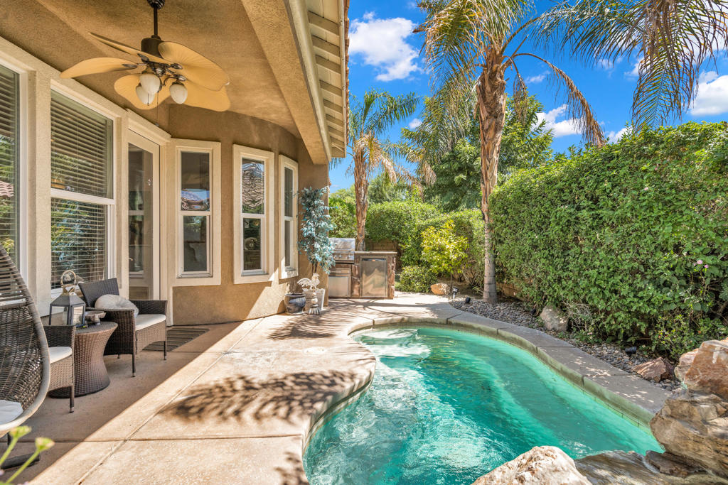 Welcome to Mission Shores, one of Rancho Mirage's most sought-after gated lake communities. This updated and modern single-story home sits proudly on a corner lot, offering privacy, style, and a desirable open-concept layout designed for desert living.The 3BD/3BA floor plan with attached casita features high ceilings, shutters throughout, and contemporary finishes. The chef's kitchen is the heart of the home, complete with granite countertops, a large center island, stainless-steel appliances, and ample cabinetry. A designer chandelier sets the tone in the foyer, while the adjoining great room showcases a full wet bar, cozy fireplace, and direct access to the backyard for seamless indoor-outdoor entertaining.The primary suite opens directly to the pool patio and offers a luxurious bath with soaking tub, walk-in shower, dual vanities, and spacious closet. Two additional bedrooms (all on one level) provide flexible space for guests or a home office. The attached casita includes its own entrance and private bath -- ideal for visitors or extended stays.Step outside to your private backyard oasis with a sparkling pool, waterfall feature, built-in BBQ, grassy side yard, and mountain views -- perfect for relaxing or entertaining. The front gated courtyard adds another inviting outdoor space, ideal for morning coffee or evening sunsets.This home has been tastefully updated and remodeled with laminate and tile flooring, designer lighting, and modern fixtures. The laundry room features custom cabinetry, and a two-car garage provides plenty of storage.Mission Shores offers low HOA dues, covering gated access, community maintenance, and lake upkeep -- plus amenities including walking paths and a dog park. Located in the Palm Springs Unified School District, near Nellie N. Coffman Middle School, with easy access to dining, shopping, and golf.Experience comfort, convenience, and style in this turnkey Rancho Mirage retreat.