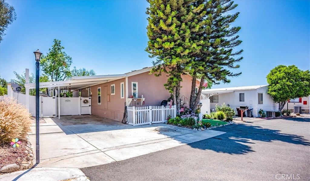 Rare opportunity to own this gorgeous View Lot home with several upgrades. This 3 bedroom 2 bath home has it all! You will first notice the Porch Descking which covers the side and front, perfect to relax or enjoy your morning coffee. Once inside you will see remodled the Kitchen with all new cabinets, back splash and beautiful Quartz Counters. Surrouinding the Kitchen is the Living Room, Dining Room., and Family Room. Great Open Floorplan. Down the hall you'll find 3 bedrooms and 2 Baths. The Second bath has also been remodled. At the end of hall is the Large Master Bedroom with Walk In Closet. The Master Bath has Double Sinks, Large Garden Tub and Shower. The home was paintetd inside and out 3 yeras ago and added new vinyl flooring throughout. Other upgrades include New AC Compressor, Tankless Water Heater, and New Vinyl Fencing. There is ample Parking (Fit up to 4 cars), and there are Double Sheds for additional Storage. This home also offers Low Maintenance Landscape. All this in one of the most unique and sought after Parks in the IE Rancho Caballero Park with amenities galore which include two Pools (One Olympic Size and One heated year round) Spa, Tennis Court and 2 Pickleball Courts, Dog Park, and Large Clubhouse, Workout Room and Ball Field and Kids Playground.