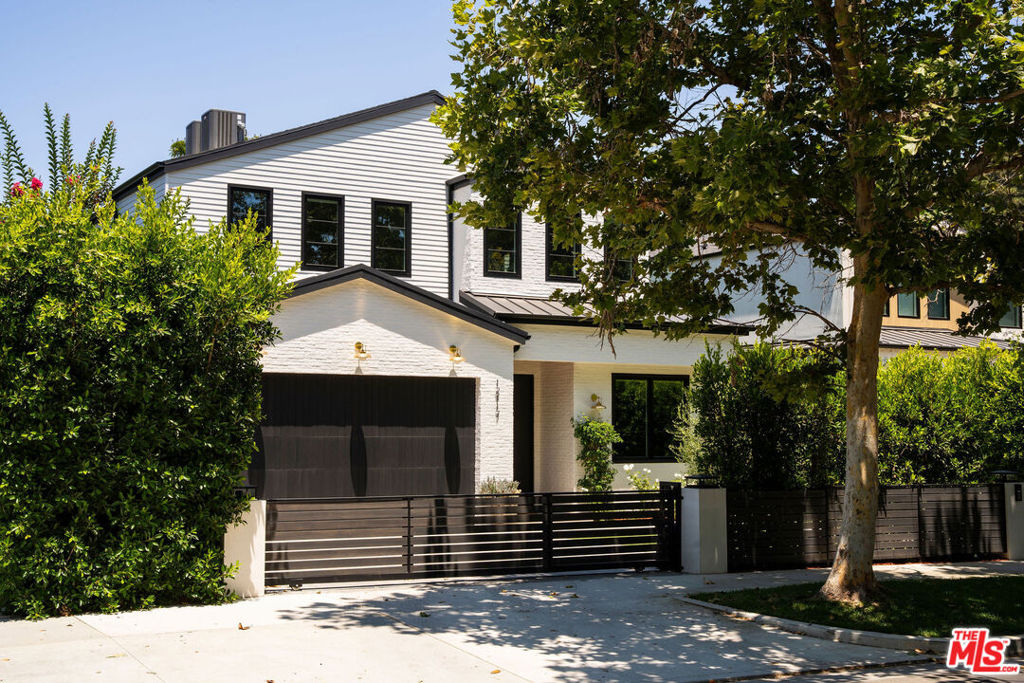 Situated in the heart of Studio City's prestigious Silver Triangle, this newly constructed modern home blends luxurious design with thoughtfully integrated high-end upgrades. Featuring a spacious 5 bed, 5.5 bath main house and a fully outfitted 1 bed, 1 bath ADU, the property offers exceptional versatility for both everyday living and entertaining. The living room features an oversized sliding glass door that opens effortlessly to the backyard, offering seamless indoor/outdoor living. A formal dining room flows into the gourmet chef's kitchen, outfitted with top-of-the-line Thermador appliances, custom cabinetry, and a massive island perfect for casual gatherings or hosting guests. Upstairs, four generously sized ensuite bedrooms await, each with soaring vaulted ceilings. The luxurious primary suite offers a peaceful retreat, complete with a custom walk-in closet, elegant fireplace, and a spa-inspired bathroom with an oversized shower, soaking tub, double vanity, and a dedicated makeup area. Air quality is carefully maintained with dedicated monitoring systems on both floors of the main house as well as in the pool house, ensuring a healthy indoor environment. For added peace of mind and sustainability, the home includes a whole-house three-stage water filtration and conditioning system, along with a reverse osmosis five-stage drinking water tap in both the main residence and pool house. The ADU, with its own full kitchen, bedroom, bath, and living area, is perfectly suited for guests, or used as a guest suite, office, or private gym. Designed with entertaining in mind, the backyard retreat features a sparkling pool and spa, an outdoor kitchen, cozy fire pit, and low-maintenance artificial turf. Located south of the Boulevard and walking distance to Carpenter Elementary School, Fryman Canyon, and the best of Studio City's dining and shopping, this home is a rare offering that combines thoughtful design, luxury upgrades, and prime location in one exceptional home.