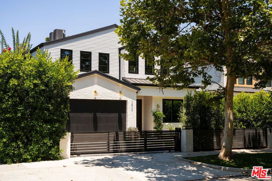 Situated in the heart of Studio City's prestigious Silver Triangle, this newly constructed modern home blends luxurious design with thoughtfully integrated high-end upgrades. Featuring a spacious 5 bed, 5.5 bath main house and a fully outfitted 1 bed, 1 bath ADU, the property offers exceptional versatility for both everyday living and entertaining. The living room features an oversized sliding glass door that opens effortlessly to the backyard, offering seamless indoor/outdoor living. A formal dining room flows into the gourmet chef's kitchen, outfitted with top-of-the-line Thermador appliances, custom cabinetry, and a massive island perfect for casual gatherings or hosting guests. Upstairs, four generously sized ensuite bedrooms await, each with soaring vaulted ceilings. The luxurious primary suite offers a peaceful retreat, complete with a custom walk-in closet, elegant fireplace, and a spa-inspired bathroom with an oversized shower, soaking tub, double vanity, and a dedicated makeup area. Air quality is carefully maintained with dedicated monitoring systems on both floors of the main house as well as in the pool house, ensuring a healthy indoor environment. For added peace of mind and sustainability, the home includes a whole-house three-stage water filtration and conditioning system, along with a reverse osmosis five-stage drinking water tap in both the main residence and pool house. The ADU, with its own full kitchen, bedroom, bath, and living area, is perfectly suited for guests, or used as a guest suite, office, or private gym. Designed with entertaining in mind, the backyard retreat features a sparkling pool and spa, an outdoor kitchen, cozy fire pit, and low-maintenance artificial turf. Located south of the Boulevard and walking distance to Carpenter Elementary School, Fryman Canyon, and the best of Studio City's dining and shopping, this home is a rare offering that combines thoughtful design, luxury upgrades, and prime location in one exceptional home.