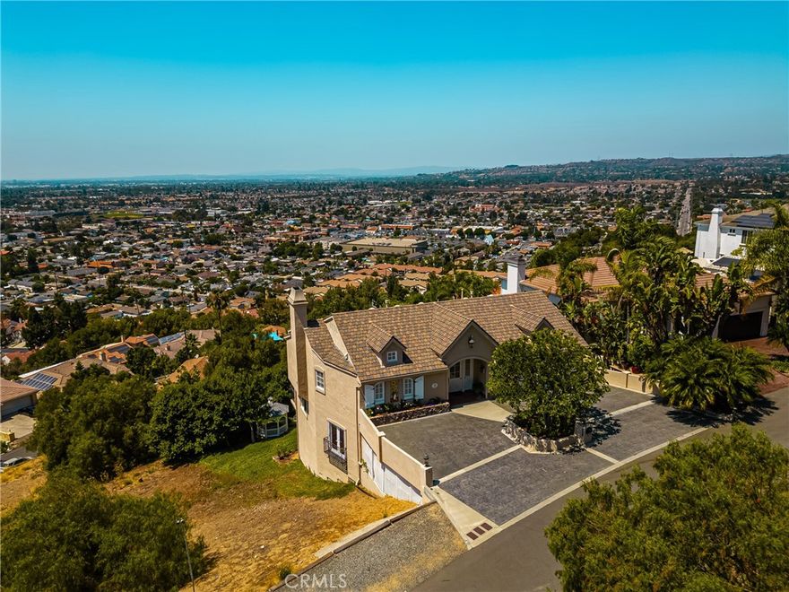 PRICE IMPROVEMENT! CUSTOM BUILT HOME WITH INCREDIBLE UNOBSTRUCTED VIEWS FROM LA TO CATALINA, BIG A & DISNEYLAND FIREWORKS & JAW DROPPING SUNSETS!! THREE ENSUITE BR/BA, WITH UPPER & LOWER PRIMARIES, IS IDEAL FOR MULTI-GENERATIONAL LIVING. EASY TO ACCESS & CHOICE OF ORANGE OR TUSTIN SCHOOLS. A rare offering in North Tustin's Panorama Heights neighborhood, this home was designed with multi-generational living in mind, offering space that balances togetherness and privacy and the flexibility modern families crave. It's also easy to reach from the base of the hill--only three simple turns before you pull directly into your driveway & garage from the level, mostly single load street. Once inside, you'll enjoy views from virtually every room with no interference by power poles/lines or rooftops. Three bedroom/bath suites plus a 4th BR/office/flex room. On the lower level, there's a large view-oriented family room with pool/game table included, and a MULTI-PURPOSE BONUS ROOM with raised platform area, ideal for a MUSIC/DANCE/EXERCISE STUDIO, CHILDREN'S PLAYROOM, SCREENING ROOM OR THAT SPECIAL SPACE YOU NEED! Shaded balconies on both levels overlook a private landscaped rear yard with meandering rock path leading to a charming gazebo. Partially finished storage basement.
