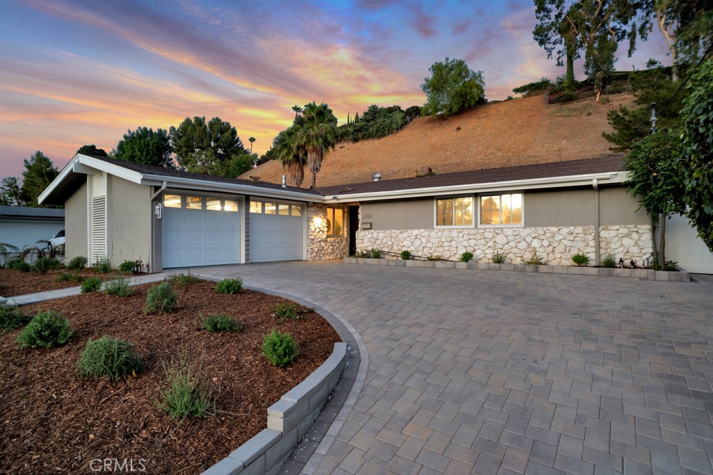 Welcome to a truly exceptional residence that seamlessly blends modern luxury with timeless comfort. This beautifully upgraded home sits on a massive 12,059 square foot lot and features a thoughtfully designed family floor plan with 3 bedrooms, 2 bathrooms, and 1,404 square feet of elegant interior space. No detail has been spared in the home’s transformation, with high-end finishes and designer touches throughout. From the sleek custom cabinetry to the premium flooring and curated fixtures, every inch reflects upscale living. The layout is open, functional, and ideal for both entertaining and everyday family life. Step outside into a private oasis where the backyard has been reimagined with modern, clean lines and resort-style features. A newly remodeled pool takes center stage, surrounded by stylish hardscaping, lush greenery, and plenty of space to lounge, play, entertain guests, or enjoy breathtaking daily sunsets. Set on a quiet, tree-lined street in one of Woodland Hills’ most desirable pockets, this turnkey gem offers unmatched privacy, comfort, and sophistication. A rare opportunity to own a fully upgraded home with a spacious yard in a premier location.