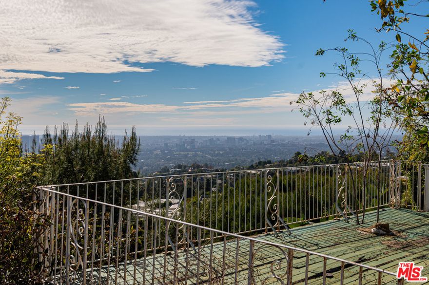 Unique opportunity to acquire a property in prime Trousdale under construction with spectacular views of the LA basin and ocean. The buyer can buy the property and finish it to their own taste. Much of the major construction has been completed while some of the finishes have not been done. The home has extraordinary scale, with a very open floor plan with pocket doors creating the ideal indoor outdoor flow, perfect for entertaining.  There are dramatic sweeping views from the house and pool area. Large flat pad offers generous motor court which can be gated for privacy and security.  The back yard has two large decks over the slope that could not be built today given current codes.