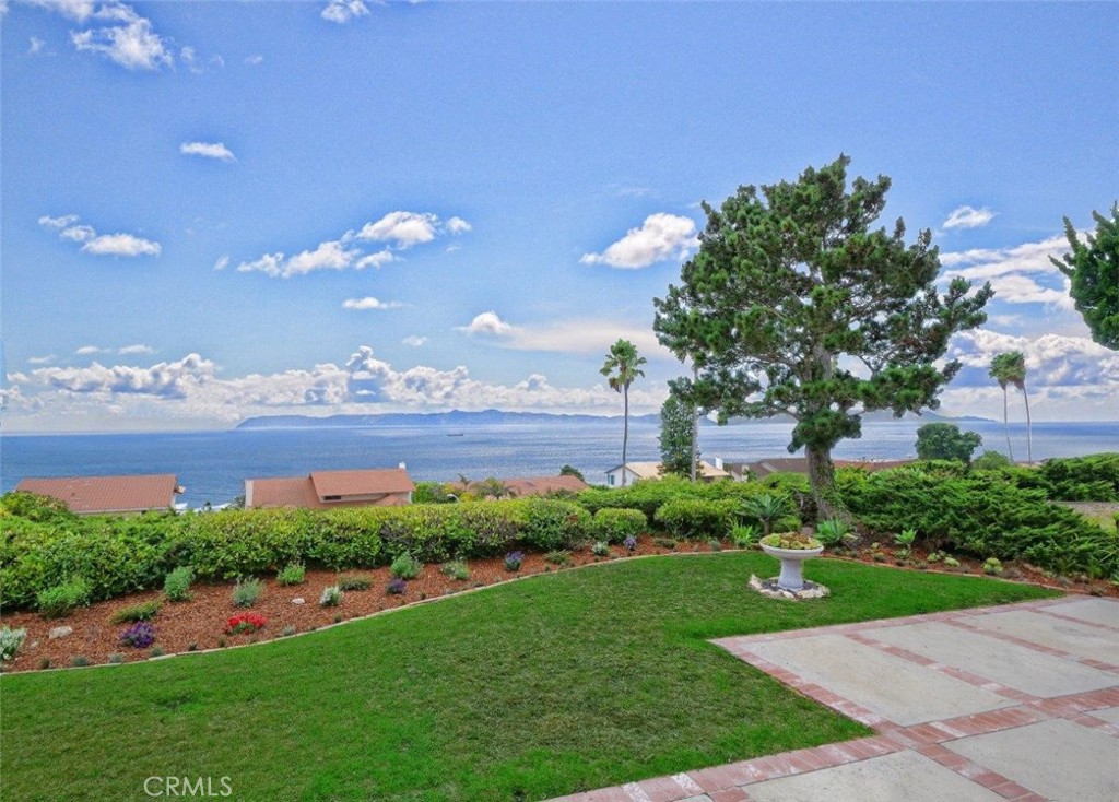 View! View! View! Perched in the heart of Palos Verdes, this rare single-level home offers unobstructed, panoramic views of the ocean, Catalina Island, Trump Golf Course/Peninsula, and the Pacific coastline. A true gem for both buyers and builders, it presents the perfect opportunity to remodel or reimagine to your own taste. The dramatic two-story, double-door entry and foyer open to a spacious floorplan designed for privacy and entertaining. In the living room, there is an impressive cathedral ceiling, while in the family room you will find a wet bar; both adorned with a cozy fireplace. Each also features a sliding door that expands the breathtaking views outdoors, leading to a backyard with an open patio, lush lawn, and charming landscaping, perfect for al fresco dining and outdoor living. The oversized kitchen with casual dining area flows seamlessly into the formal dining room, creating endless potential for a stunning redesign. In addition, there is a powder room in the living area for added convenience. Meanwhile, the private bedroom wing includes a generous primary suite on the view side with double-door entry, walk-in closet, dressing area with additional closet, sink, and vanity desk, plus an en-suite bathroom with a bathtub and second sink. Three additional bedrooms are well-sized and share a large hallway bathroom with a double-sink vanity and a separate tub/shower and toilet area, creating an ideal layout for family or guests. This house is a trust sale, and the property is priced accordingly to be sold "As Is" in its present condition. With an unbeatable location near top-rated schools, golf courses, parks, and all the best of the Peninsula lifestyle, this single-story home is all about gorgeous views, potential, and opportunity. Bring your vision, this is where your dream home begins.