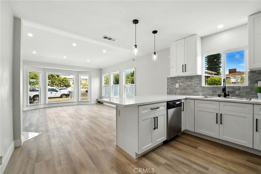 Welcome to an exceptional bargain in the city of Gardena! This beautifully remodeled 3-bedroom, 2-bathroom home (1,221 sq ft) sits proudly on an oversized corner lot (7,496 sq ft) and offers a perfect blend of modern luxury, comfort, and long-term value. With termite fumigation already completed, central heating and AC, and a PAID-OFF SOLAR SYSTEM, this residence is truly move-in ready.

Step inside and be impressed by the inviting open-concept layout, where the spacious living room—with its elegant open fireplace—flows seamlessly into the dining area and stunning kitchen. Flooded with natural and recessed lighting, the home provides an atmosphere ideal for both relaxation and entertaining. Enjoy generously sized bedrooms, beautifully remodeled bathrooms (including a private en-suite), an indoor laundry area, and a chef-inspired kitchen featuring ample counter space and brand-new appliances.

Outside, the possibilities are endless. The fully fenced property offers access from three sides, making it incredibly versatile. Whether you drive up to the oversized two-car garage (accessible through a sliding gate) or step onto the new deck from the primary suite, you’ll immediately see the immense potential—including the opportunity to build a 1,000 sq ft ADU in the backyard without impacting garage space.

This is a rare opportunity to own a turnkey home with outstanding features, unbeatable potential, and incredible value. Don’t miss out—homes like this don’t come around often. Hurry!