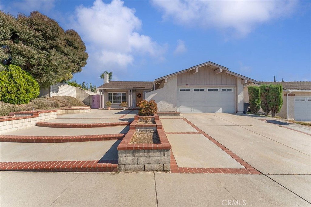 Amazing curb appeal and a beautiful hardscape in the front of the house!!! Desirable single level, 4 br/2baths + sunroom home in great , quiet neighborhood of West Covina. Living room with fireplace and wood floors. Oakwood kitchen cabinets, granite countertops, island for more working space, tile floor. Kitchen opens to a good size Dining-room. This home has also a great 23x9.5 feet sunroom - that adds additional living space!! 2 car attached garage with direct access to home. The property is conveniently located to shopping centers, restaurants, freeways. A must see!!! Please call today for a private viewing of the beautiful home!