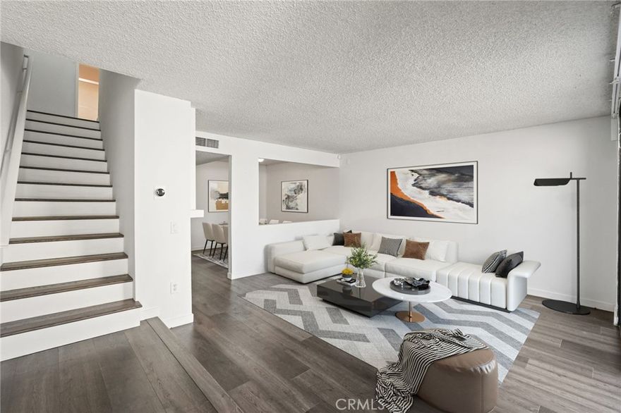 Welcome to this spacious two-story condo in the heart of Woodland Hills. With a practical layout and new vinyl flooring throughout, this home offers comfort, functionality, and room to make it your own.



The main level features two separate dining areas, a generously sized kitchen with ample counter space and modern appliances, and a cozy living room with a fireplace — perfect for relaxing evenings at home. Just off the living area, sliding glass doors open to a private enclosed patio, ideal for enjoying your morning coffee, entertaining guests, or getting some fresh air.



Upstairs, you’ll find two well-sized bedrooms, each with its own walk-in closet. One bedroom includes an ensuite bathroom, offering privacy and convenience. The laundry area is tucked into a hallway closet with hookups for a side-by-side washer and dryer.



Additional highlights include central air and heat, and two assigned parking spots in a gated garage. The community features a pool, spa, and landscaped courtyards, all within a secure and well-maintained complex.



Conveniently located near Warner Center, Westfield Topanga, The Village, restaurants, cafes, and with easy access to the 101 and 118 freeways — this condo offers space, comfort, and a great Woodland Hills location.