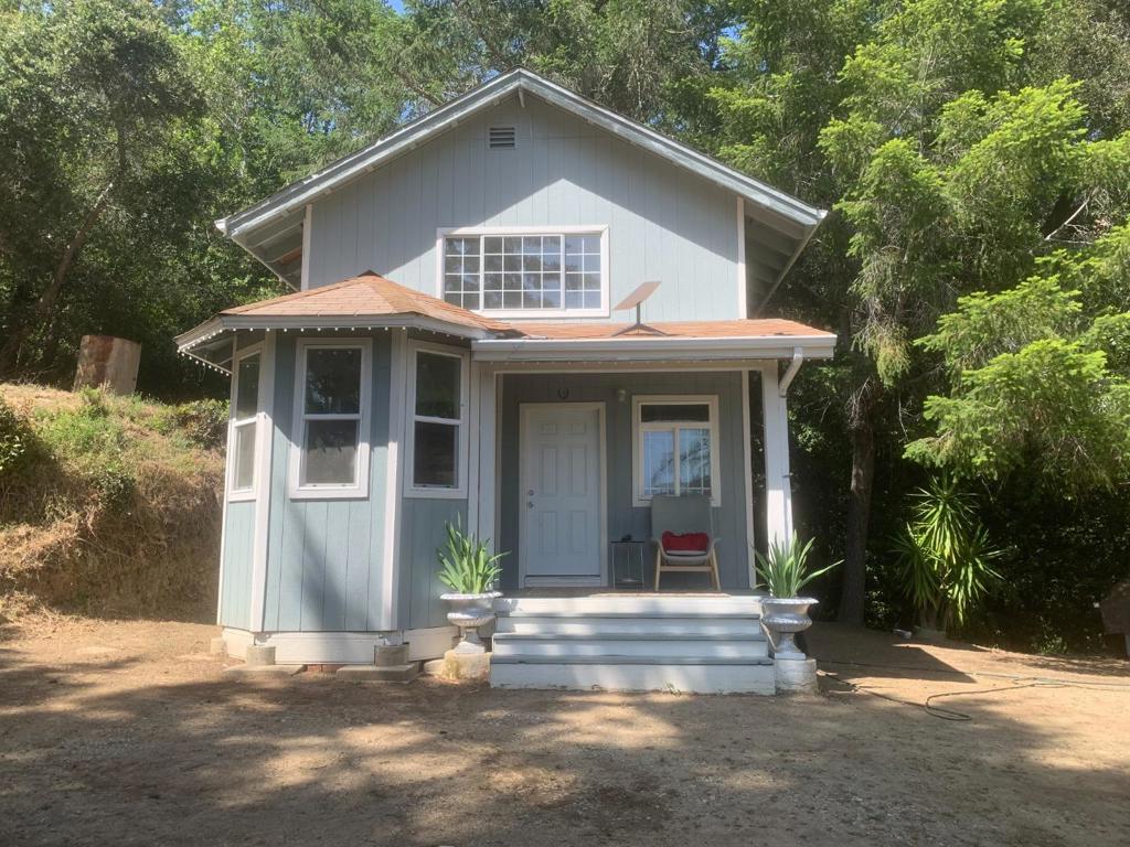 Welcome to this charming 2-bedroom, 1.5-bathroom residence located in the vibrant Los Gatos mountains, just 25 minutes to downtown Los Gatos or the Santa Cruz beaches. The Summit Store is just minutes away. The well-appointed kitchen includes a refrigerator, range, and dishwasher making meal preparation convenient and efficient. Enjoy meals in the dining area or outside while taking in the majestic view of the Demonstration Forest. Excellent nearby mountain biking. The living space is enhanced by a warm and welcoming fireplace, perfect for relaxing evenings. The property also features a washer and dryer, adding convenience to your daily laundry routine. Half-bath and laundry are on the ground floor while the 2 bedrooms and full bath are upstairs. Outdoor shed for storage. Home is 'off grid" and boasts of efficient solar panels and back-up batteries. Located 1 mile down a partially paved and partially dirt road. Very peaceful and quiet. Unfortunately, bank financing is not available on this home, cash buyers only. Home is shown by appointment only to qualified buyers with proof of funds. 48 hour notice required. NO DRIVE-BYS in respect to neighbors' privacy. Property has about 3/4 acre of useable land around the house. Most of the property is hillside.