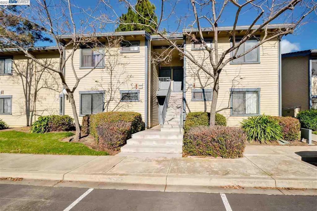 Welcome to 6039 Joaquin Murieta Avenue #B! This beautiful ground-floor condo is perfectly nestled within the sought-after Newpark Village community. The home features an abundance of windows that invite natural light into every corner, highlighting the high ceilings and open, airy atmosphere. The ideal floor plan offers a spacious living room with a charming fireplace, seamlessly flowing into the dining area and kitchenperfect for both everyday living and entertaining. The generously sized primary bedroom includes a large walk-in closet and an en-suite bathroom with a modern dual-sink vanity. Step outside to your private backyard patio, an inviting retreat ideal for relaxing or enjoying outdoor dining. Additional highlights include updated laminate floors, an in-unit washer and dryer, a convenient storage closet, and two designated parking spaces (1 covered carport and 1 uncovered space). Enjoy exceptional community amenities such as multiple swimming pools, tennis courts, and a fitness center. The location is a commuters dream, close to I-880, the Dumbarton Bridge, BART, AC Transit, and Silicon Valley shuttle stops. Just minutes away are Newpark Mall, Ohlone College Newark campus, highly rated schools, scenic wildlife trails, restaurants, and entertainment options.