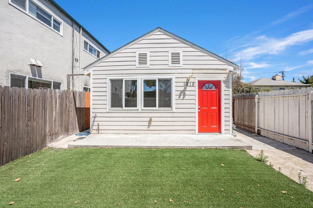 This charming, cottage-style Berkeley gem is conveniently positioned near all the city's best attractions! Recently rebuilt in 2018, it comprises 3 modest bedrooms, 2 full bathrooms, and nearly 900 square feet of practical living space. The interior boasts a bright and airy atmosphere with an open floor plan accentuated by the rich and inviting hues of the beautiful wood laminate flooring. Its kitchen comes well-appointed with stainless steel appliances, attractive cabinetry, a countertop made of polished granite, and a convenient breakfast bar. The sunny, fully fenced front yard with lawn adds a touch of nature to this charming home and provides a delightful outdoor space for relaxation and recreation! Situated conveniently near the Pacific East Mall, this home provides easy access to shopping, dining, and other essential services, as well as freeways. Residents have the opportunity to enjoy outdoor recreation in nearby parks, including Tilden Regional Park and Wildcat Canyon Regional Park, which offer scenic views and opportunities for exercise. With the University of California, Berkeley, and several other institutions of higher education located in the city, this abode is an attractive home for students and professionals in academia.