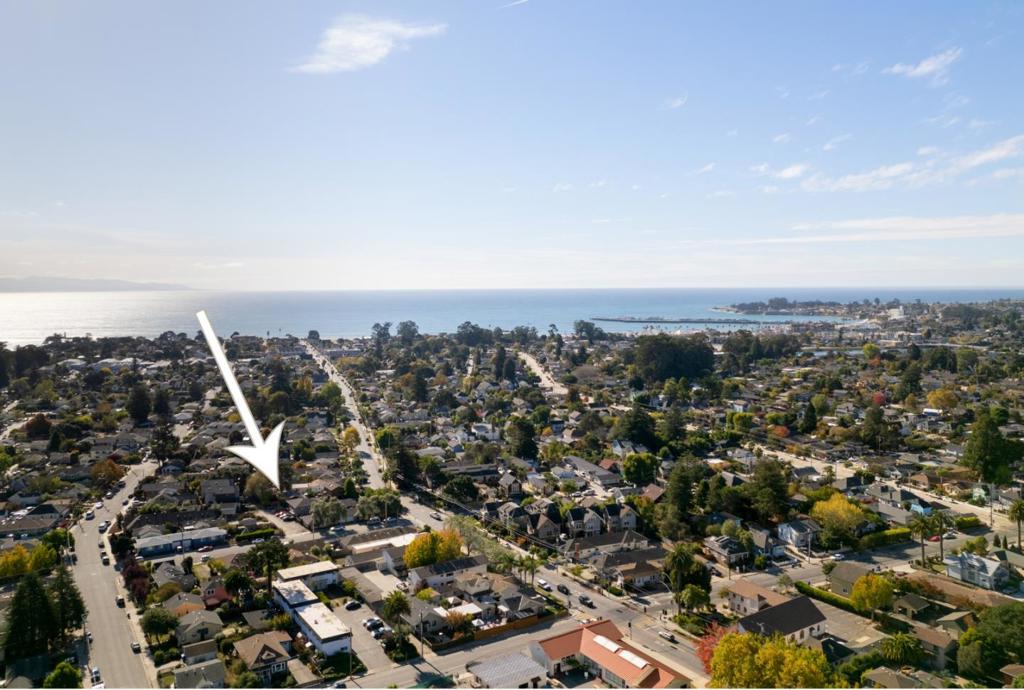 Tucked away in the heart of sunny Seabright, this classic beach bungalow offers the perfect blend of comfort, privacy and coastal vibes, with peace and quiet and an abundance of natural light inviting you in. A remodeled kitchen opens seamlessly to the dining and living areas and right out to the deck, creating the ideal flow for everyday living and entertaining. Newer roof and HVAC, tankless water heater, updated bath, double pane windows and plank flooring, keep it stylish and practical. Plus a detached 135 sq ft finished outbuilding with wd floors and electricity, well-suited for a home office, studio, or creative space. The alleyway entrance on Windsor rather than Seabright and a gated front yard create a relaxed ambiance for this minimalist-style home. Hop on the bike and you are just minutes from the best of Santa Cruz beaches, shops and eateries, the harbor, hiking and biking trails. Seabright itself embodies the quintessential coastal vibe, with dog-friendly parks, summer bonfires and sailboat races, lively restaurants and bars, and Midtown Block Parties. Whether searching for a primary residence or weekend getaway, this home captures the spirit of Santa Cruz; laid-back, welcoming, and effortlessly cool. Are you ready to make this Seabright treasure your coastal haven?