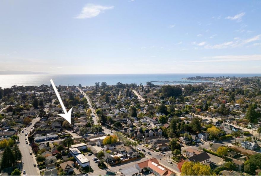 Tucked away in the heart of sunny Seabright, this classic beach bungalow offers the perfect blend of comfort, privacy and coastal vibes, with peace and quiet and an abundance of natural light inviting  you in. A remodeled kitchen opens seamlessly to the dining and living areas and right out to the deck, creating the ideal flow for everyday living and entertaining. Newer roof and HVAC, tankless water heater, updated bath, double pane windows and plank flooring, keep it stylish and practical. Plus a detached 135 sq ft finished outbuilding with wd floors and electricity, well-suited for a home office, studio, or creative space. The alleyway entrance on Windsor rather than Seabright and a gated front yard create a relaxed ambiance for this minimalist-style home. Hop on the bike and you are just minutes from the best of Santa Cruz beaches, shops and eateries, the harbor, hiking and biking trails. Seabright itself embodies the quintessential coastal vibe, with dog-friendly parks, summer bonfires and sailboat races, lively restaurants and bars, and Midtown Block Parties.  Whether searching for a primary residence or weekend getaway, this home captures the spirit of Santa Cruz; laid-back, welcoming, and effortlessly cool. Are you ready to make this Seabright treasure your coastal haven?